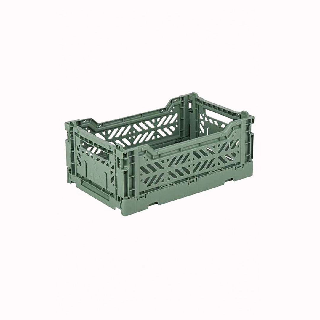 Mini Almond Green Folding Crate from Aykasa. This crate is made from 100% recyclable material and can be folded flat when not in use. It's perfect for holding books, toys, clothes, or anything else you want to organise.