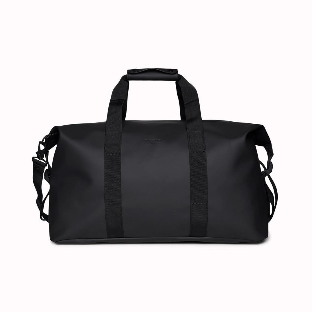 The Hilo Weekend Bag by Rains is a great contemporary gym or overnight bag. It features a single main compartment, carry handles, a detachable shoulder strap, and adjustable lock slider buckles on the sides. This brilliant waterproof duffel bag is cut from Rains’ signature waterproof PU coated fabric and is finished with coated zip and matte hardware.