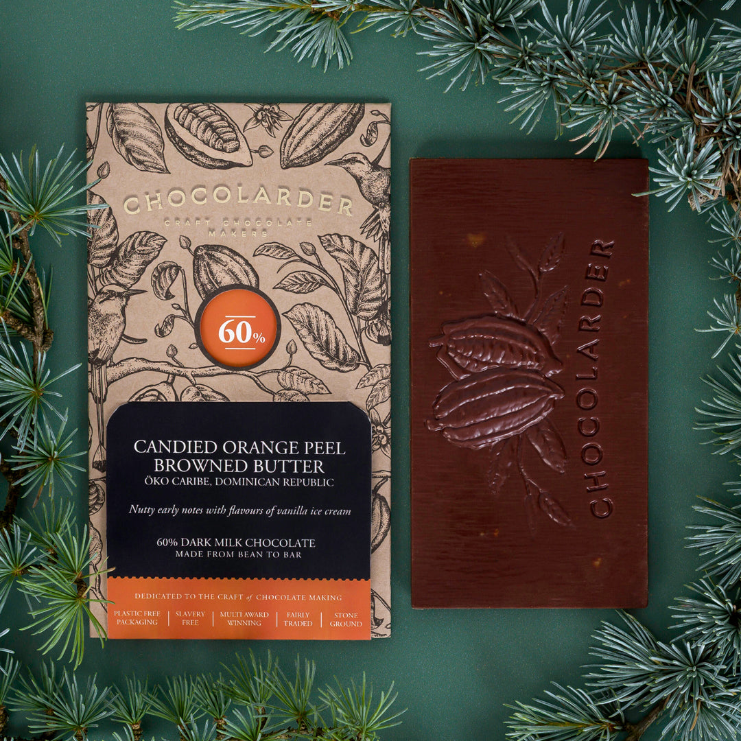 The smooth milk chocolate features scattered pieces of candied orange peel.