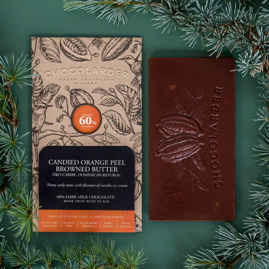 The smooth milk chocolate features scattered pieces of candied orange peel.