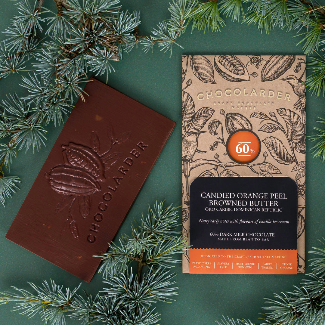 The smooth milk chocolate features scattered pieces of candied orange peel.