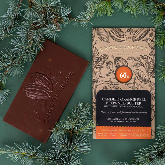 The smooth milk chocolate features scattered pieces of candied orange peel.