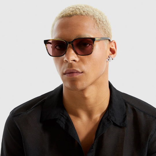 Worn by model. Strong lines, elegant and fine. The Cole sunglesses from Komono make sure to bring out your best features with their fine acetate frame. Desert Dust is a golden-brown frame colour, which looks really striking with the solid burgundy lenses.