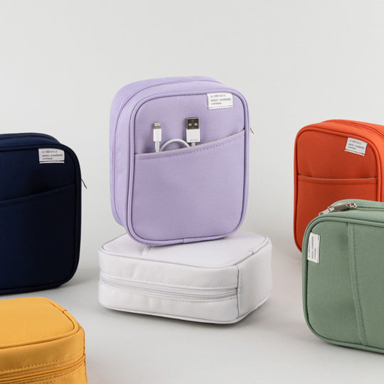 Dark Orange pocket cable pouch by Korean stationery brand Livework. Available in a choice of pleasing contemporary colours, the zipped pocket pouch opens up nice and wide, giving easy access to your charger, cables and other small tech items.