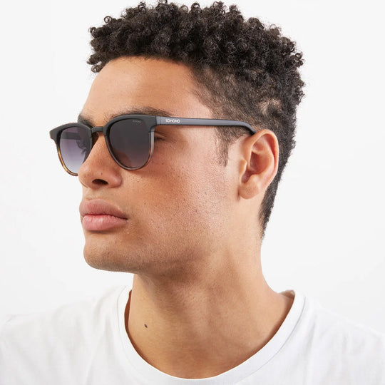 As worn by model, The Francis Black Tortoise offers unparalleled style and protection with a 139.5mm x 47.3mm Bio Nylon Frame, 100% UV400 lenses, and scratch-resistant PC lens. Featuring a frame that is matt black across the top and arms and tortoiseshell underneath paired with gradient smoke lenses, these sunglasses are both elegant and modern.