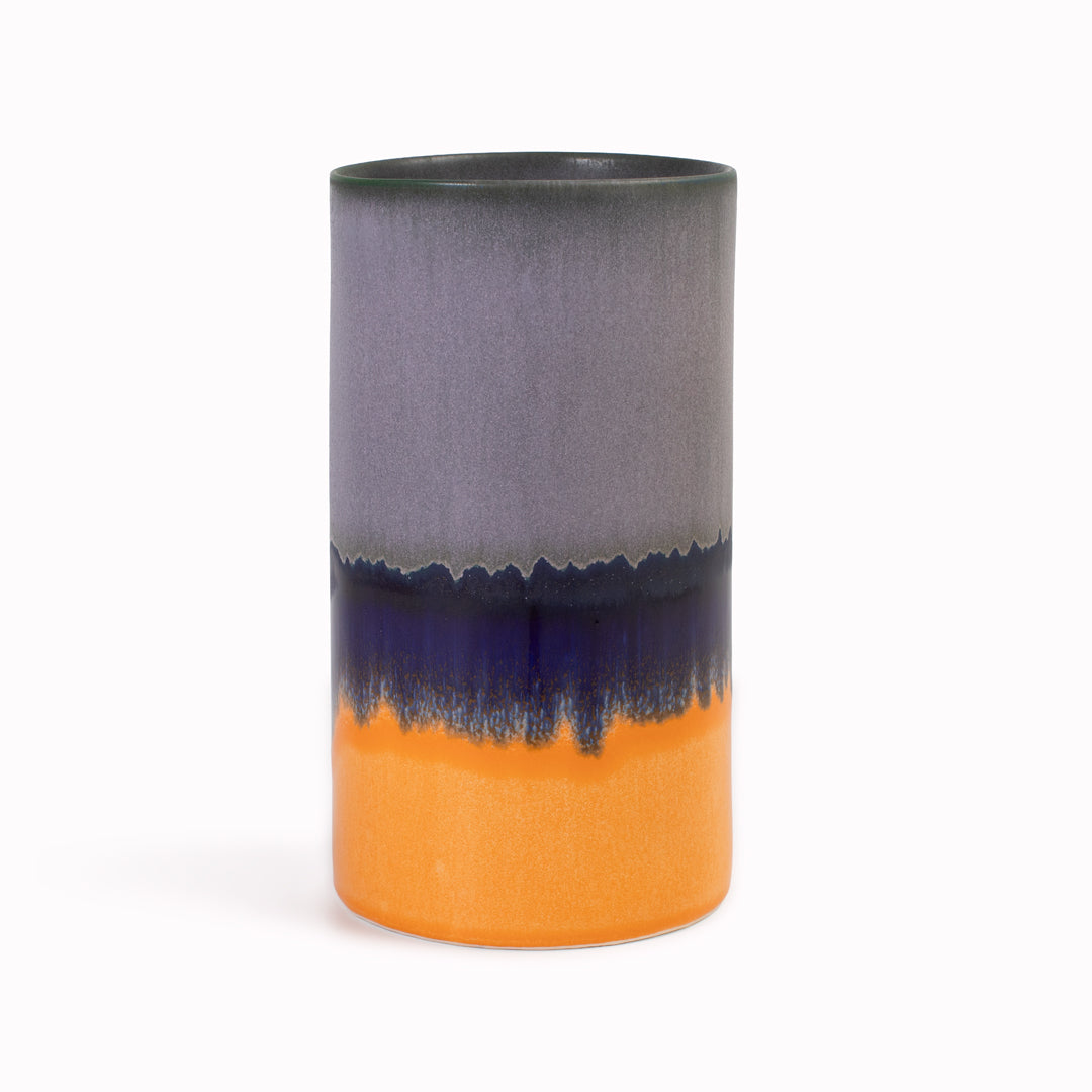 Extra Large Porcelain cylinder vase from London based SGW Lab, glazed in colourful shades of lavender, blue and orange.