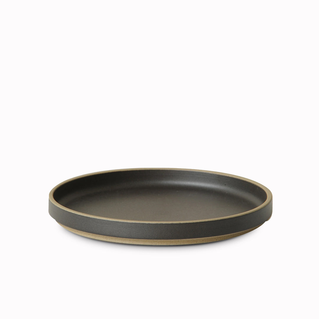 Matt black porcelain plate by Hasami Porcelain is a stackable serving plate with high rimmed edge, suitable for use as a dinner plate or a serving plate for sharing dishes or sides to accompany a meal