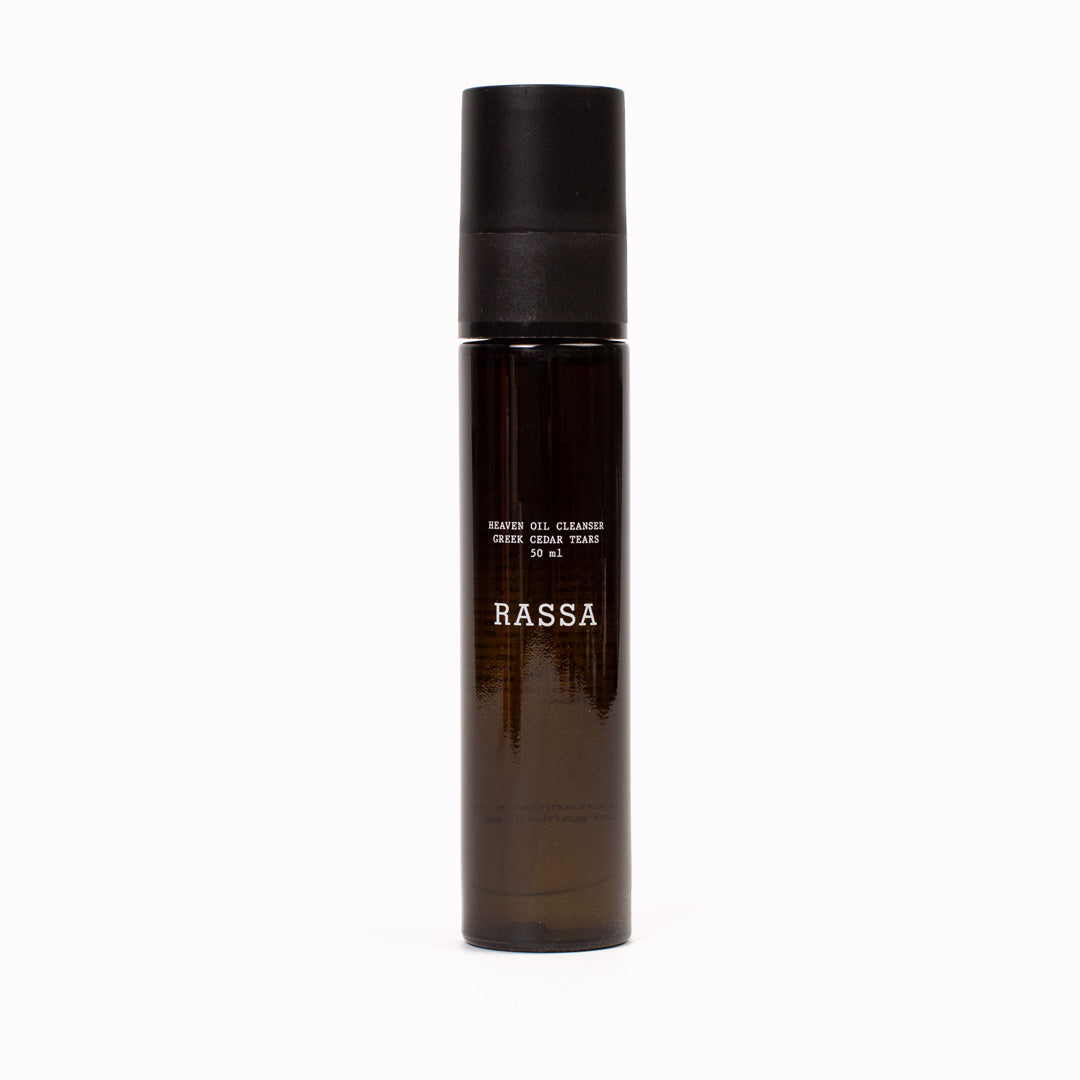 Brown bottle with black cap labeled 'RASSA' Heaven Oil Cleanser on a white background