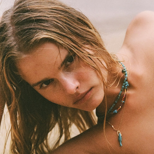 Lagoon Necklace by Anni Lu is a stunning piece crafted in brass with 18-karat gold plating and e-coating. Detailed with glass beads and composite turquoise