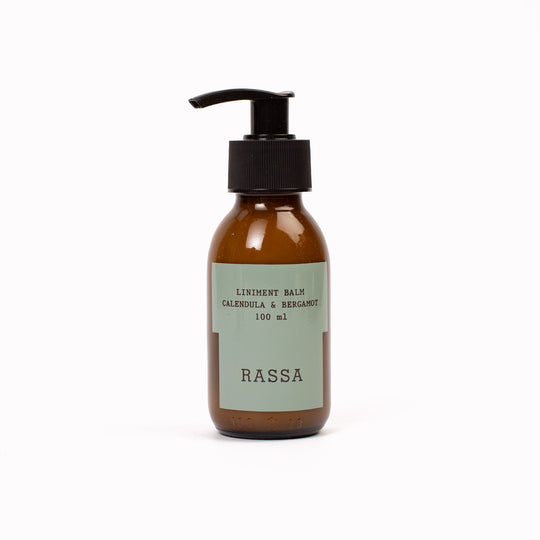 Brown bottle with pump and 'Rassa' Linament Balm label on a white background
