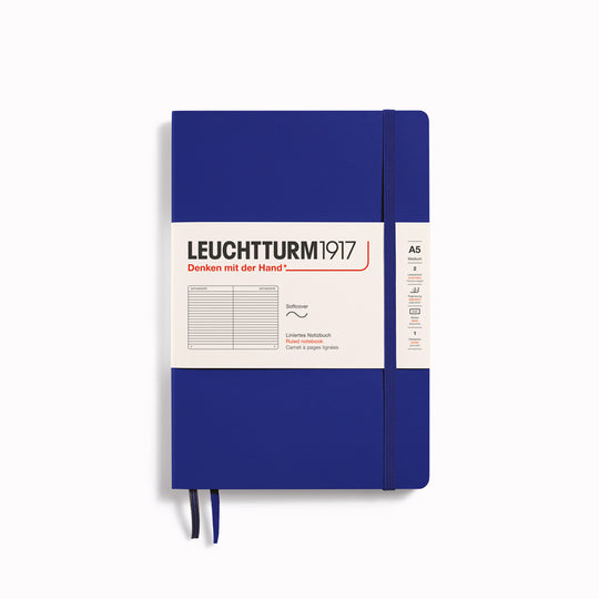 The A5 Lined Medium Notebook features 2 page markers, a blank table of contents, numbered pages, a gusseted pocket for loose notes and business cards, an elastic enclosure band