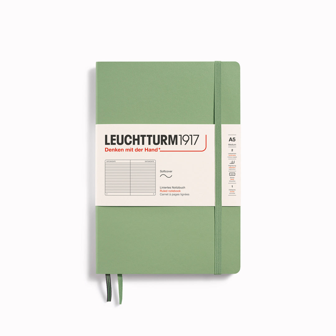 The A5 Lined Medium Notebook features 2 page markers, a blank table of contents, numbered pages, a gusseted pocket for loose notes and business cards, an elastic enclosure band