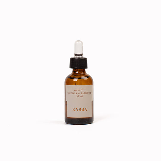 Brown glass bottle with dropper labeled 'RASSA' Moon Oil on a white background