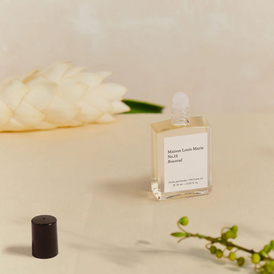 No12 Balincourt Roll on perfume lifestyle image.. Memories for enchanted summers from the founders mother's hometown of Bousval in Belgium make up the fragrance in this fresh and light perfume oil. Italian Bergamot, Valencia Orange, White Ginger Flower are the standout notes along with a little woody muskiness to keep it nice and contemporary.