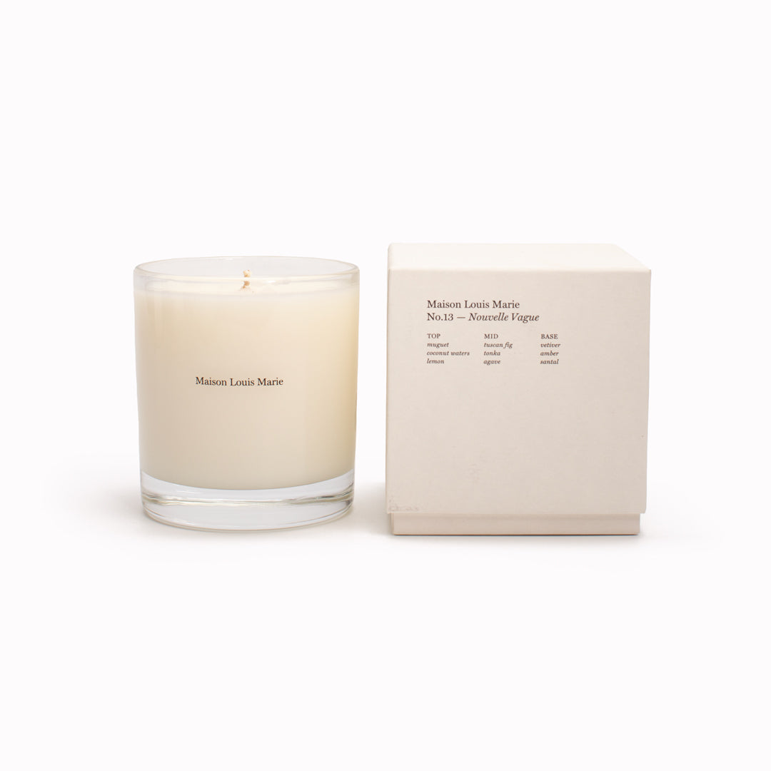 Nouvelle Vague No13 Candle with box. Oceanside streets on the  idyllic Italian island of Capri on the Amalfi coast is the inspiration behind this perfume oil. Lily of the Valley, Tuscan Fig and Tonka Bean are the standout notes with the fragrance having uplifting citrus and floral notes with an earthy tonka undertone to keep it grounded.