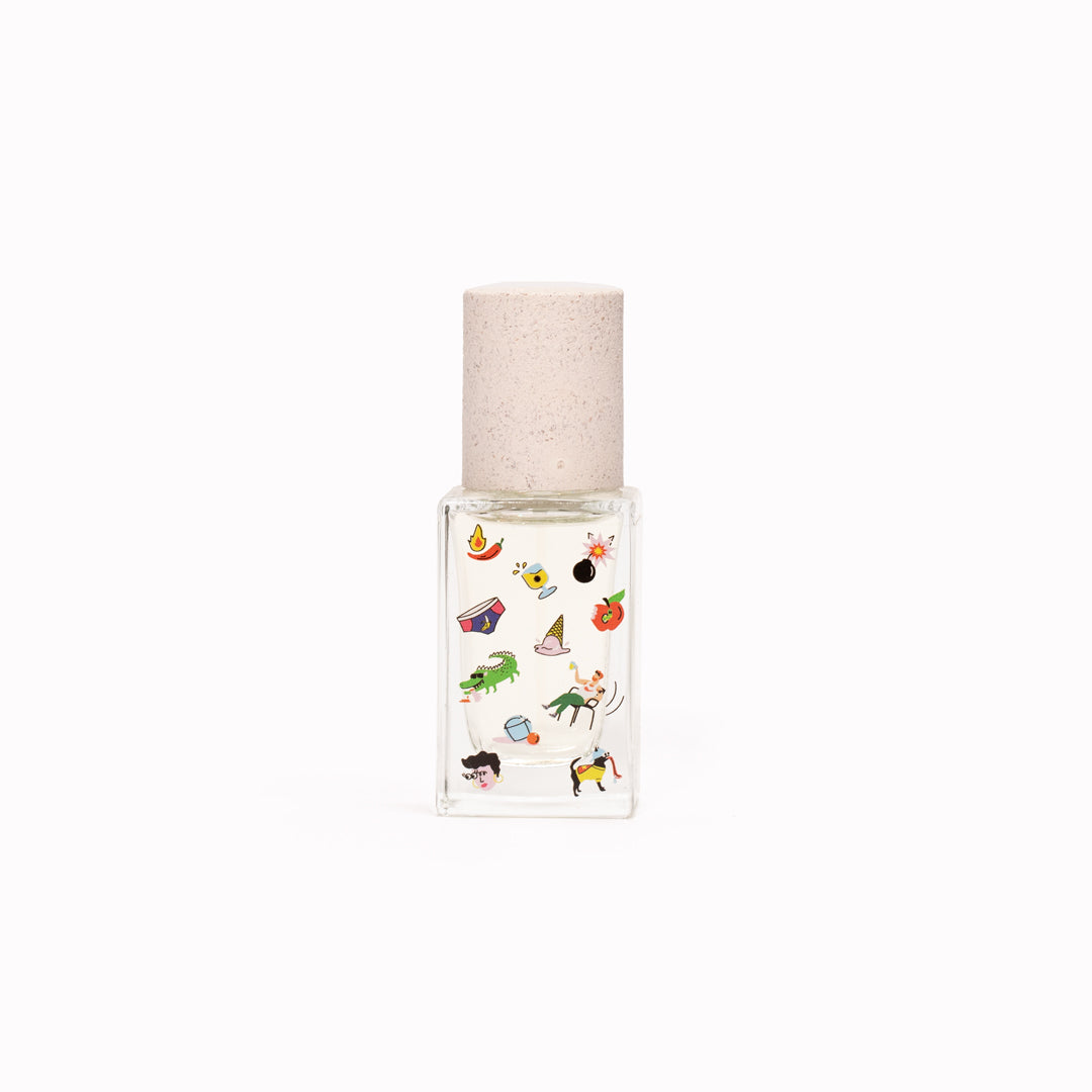 Maison Matine's 'Poom Poom' is a scent that is a carefree ode to life itself... floral, woody, musky and happy! The perfume comes in a beautiful illustrative bottle. 50ml bottle with cap off. Illustrated with cartoon-style imagery.