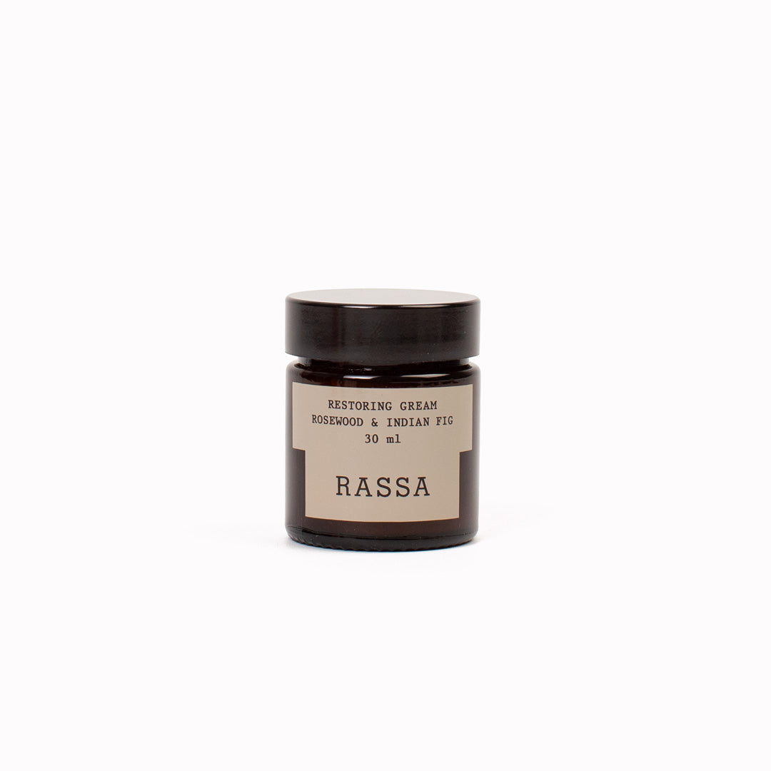 Jar of Rassa restoring cream on a white background