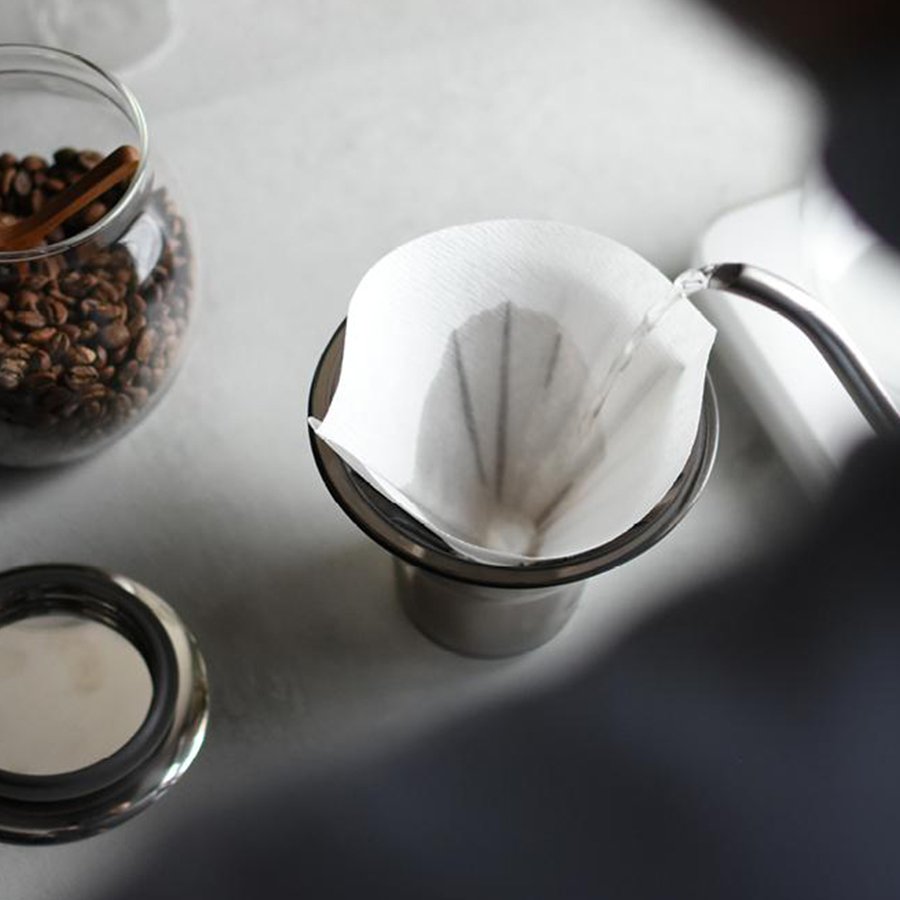 Slow coffee by Kinto Japan, pour over kettle filling filter paper
