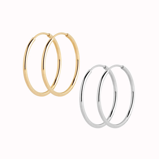 These Classic hoops from Maria Black are made from Sterling Silver and available with either White Rhodium plating or 22k Gold Plate.