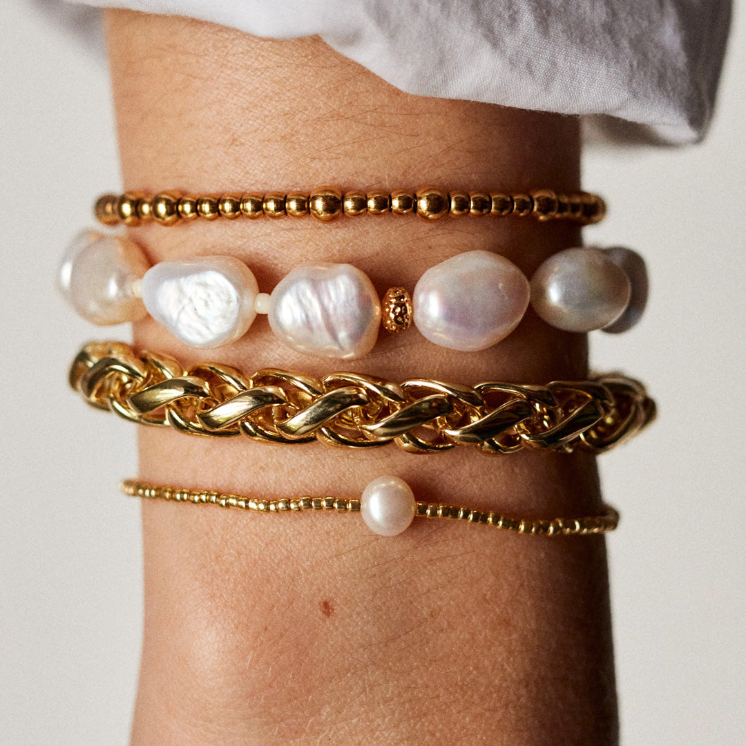 The Anni Lu Slim Goldie bracelet is a versatile piece of jewellery that offers a classic look when worn alone and layers with other pieces