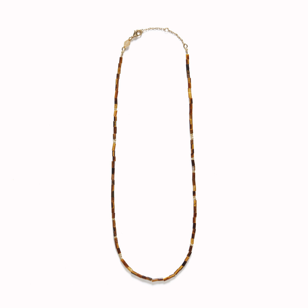 Anni Lu Sun Stalker necklace, with its Eye Of The Tiger design, is a luxurious piece that combines the timeless appeal of classic jewellery with a touch of modern flair. Crafted in brass and adorned with 18-karat gold plating plus an e-coating for durability