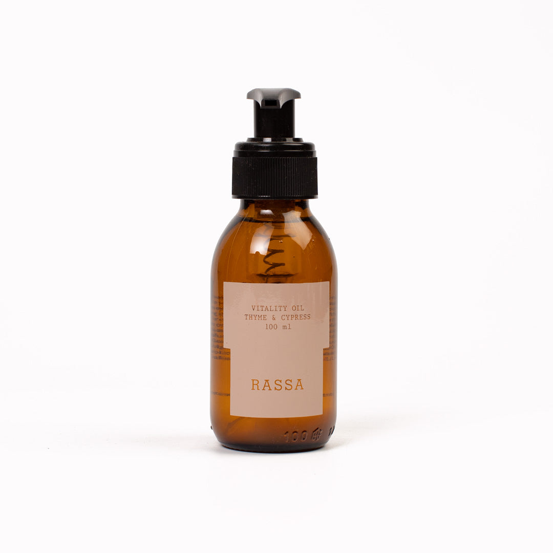 Brown bottle with black pump and Rassa Vitality Oil label on a white background