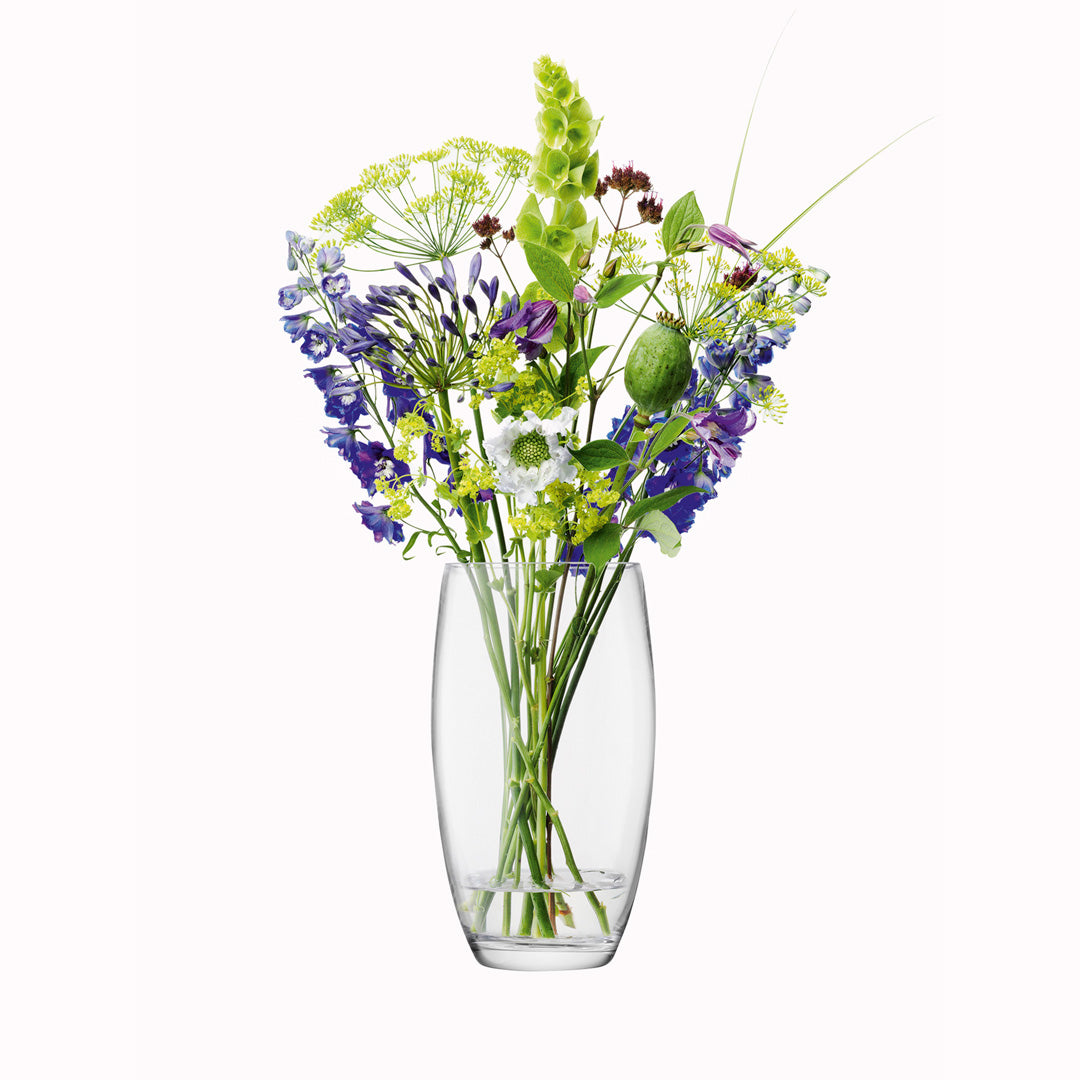 The 29cm Barrel Vase is a versatile, slender barrel shaped vase made from clear mouth blown glass. The Barrel Vase features a heavy base, thick walls and cut and polished rims with all finishing done by ha