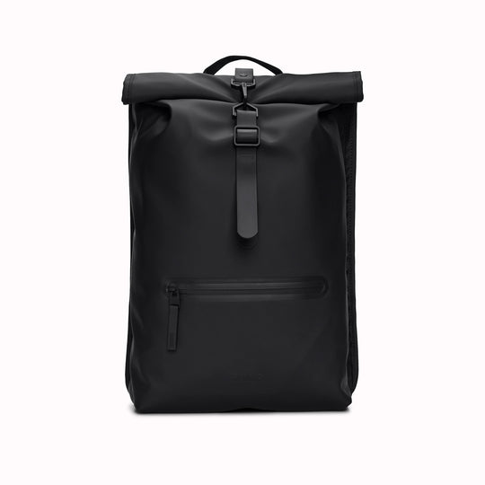 Front View of Black Rolltop Rucksack. Made from Rains’ signature waterproof fabric, this functional backpack has a roll-top closure with an adjustable strap featuring a loop for a bike lock or similar. It has a large main compartment, and an easy-access front pocket and side-access laptop compartment both with a water-repellent zipper closure.