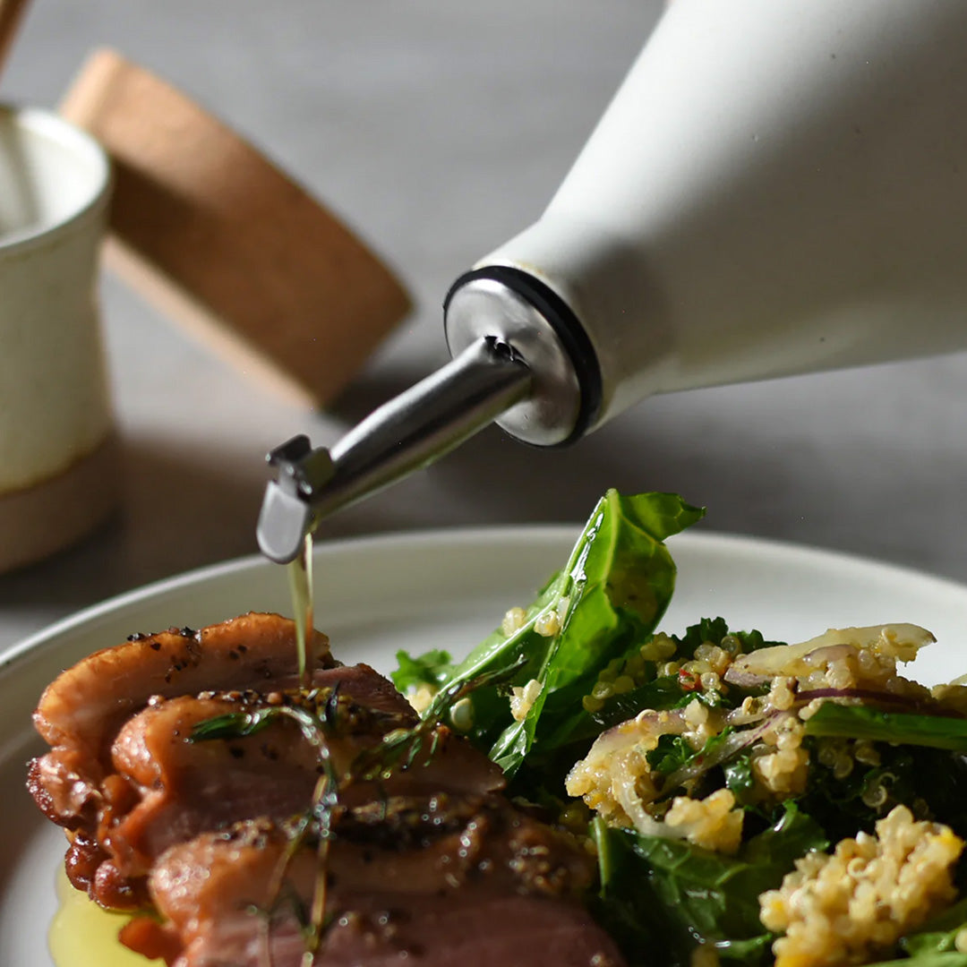 The Ceramic Lab Oil Bottle by Kinto is a stylish and functional accessory for your kitchen. This oil bottle is made of high-quality porcelain that is durable and easy to clean. The spout is designed to prevent dripping and control the amount of oil you pour. The bottle has a simple and elegant shape that complements any tableware.