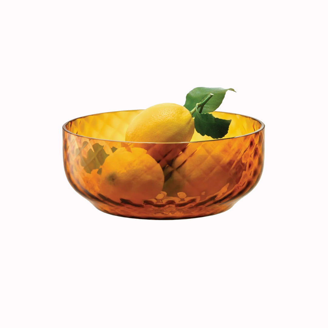 The Dapple Bowl is a lattice textured small serving or fruit bowl made from coloured amber yellow mouth-blown glass. The Dapple Bowl features a beautiful undulating textured surface that is inspired by dappled sunlight on water.