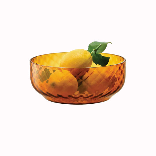 The Dapple Bowl is a lattice textured small serving or fruit bowl made from coloured amber yellow mouth-blown glass. The Dapple Bowl features a beautiful undulating textured surface that is inspired by dappled sunlight on water.