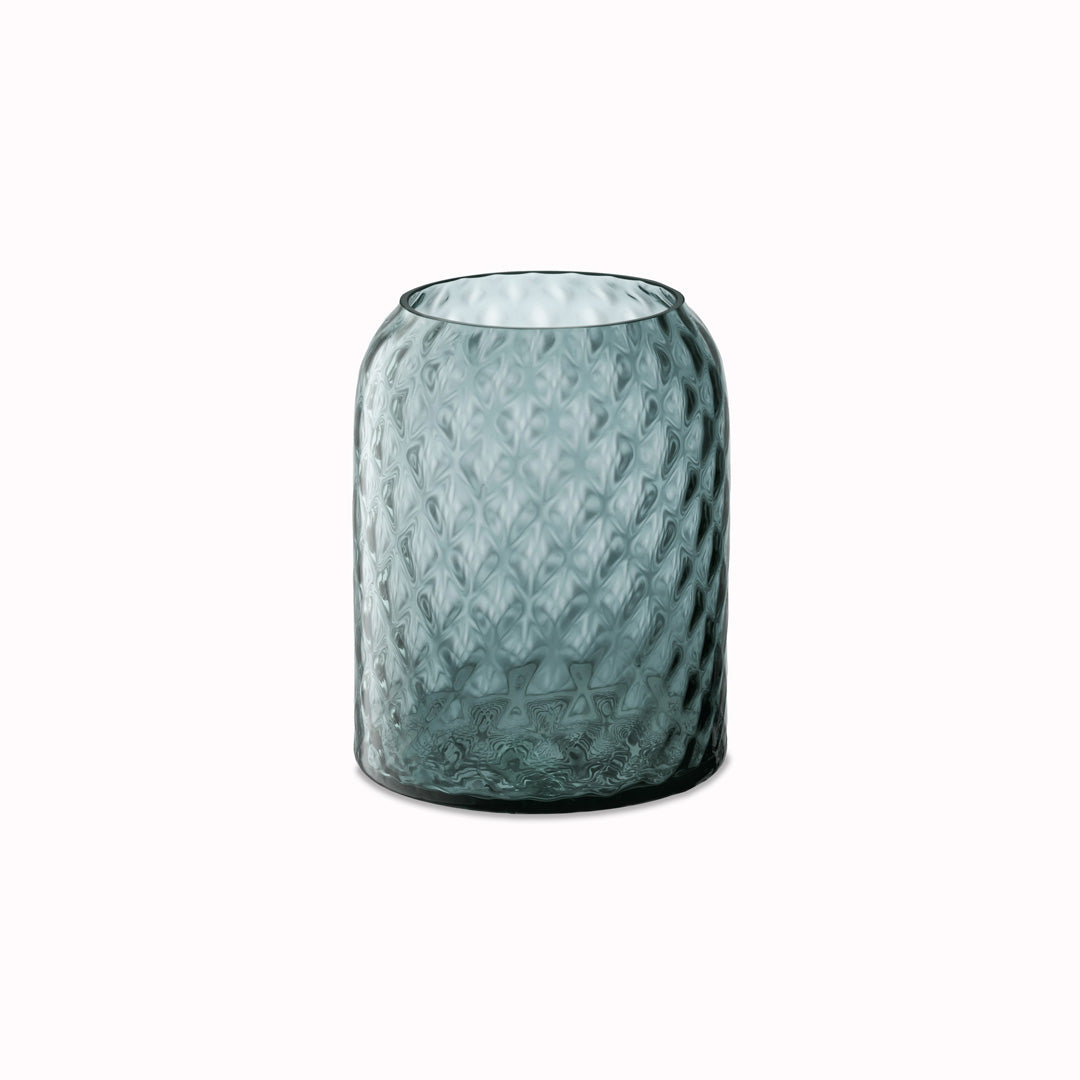 Dapple - Water Blue Vase. This medium sized vase is perfect for floral arrangements but can equally be used as candle lantern where the textured surface creates a patterned glow in a room.