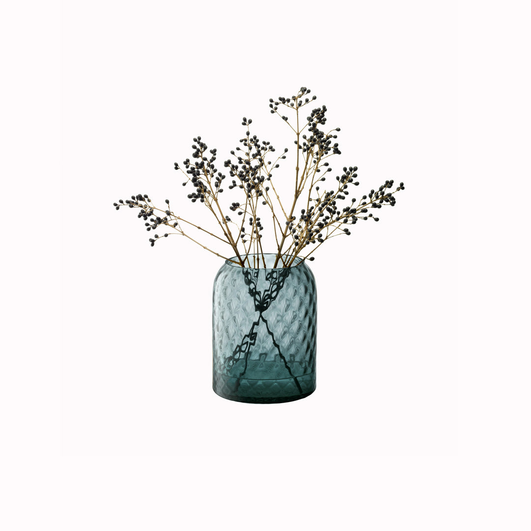 Dapple - Water Blue Vase. This medium sized vase is perfect for floral arrangements but can equally be used as candle lantern where the textured surface creates a patterned glow in a room.