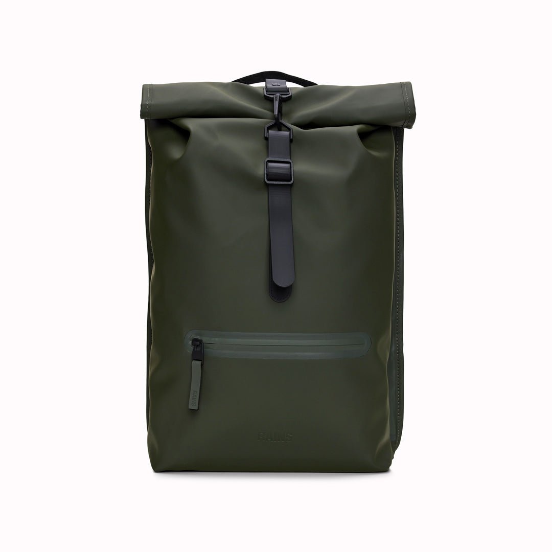 Front View of Green Rolltop Rucksack. Made from Rains’ signature waterproof fabric, this functional backpack has a roll-top closure with an adjustable strap featuring a loop for a bike lock or similar. It has a large main compartment, and an easy-access front pocket and side-access laptop compartment both with a water-repellent zipper closure.