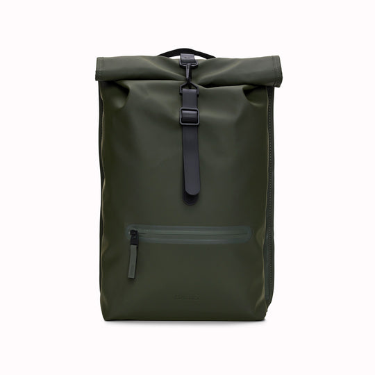Front View of Green Rolltop Rucksack. Made from Rains’ signature waterproof fabric, this functional backpack has a roll-top closure with an adjustable strap featuring a loop for a bike lock or similar. It has a large main compartment, and an easy-access front pocket and side-access laptop compartment both with a water-repellent zipper closure.