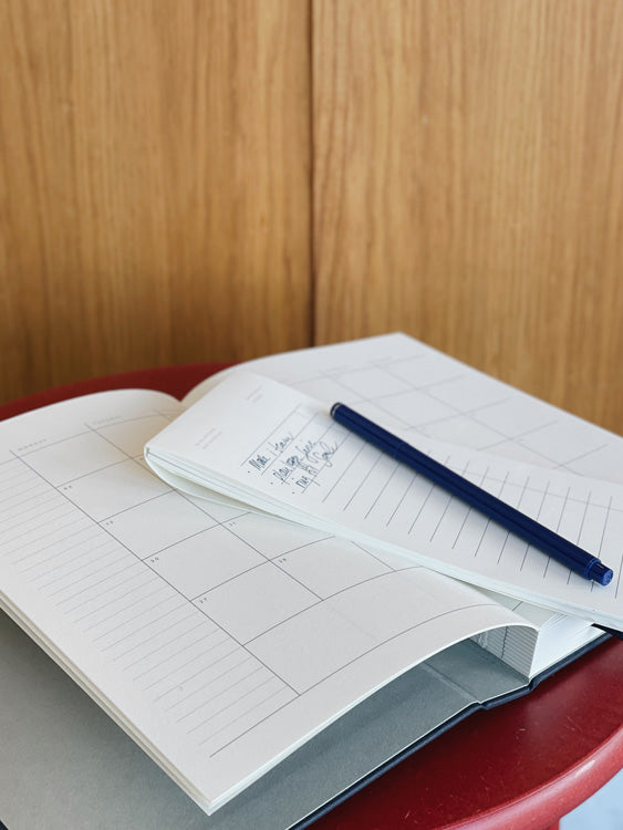 Notem Stationery, Danish Stationery brand. View on desk of pen resting on memo pad and journal