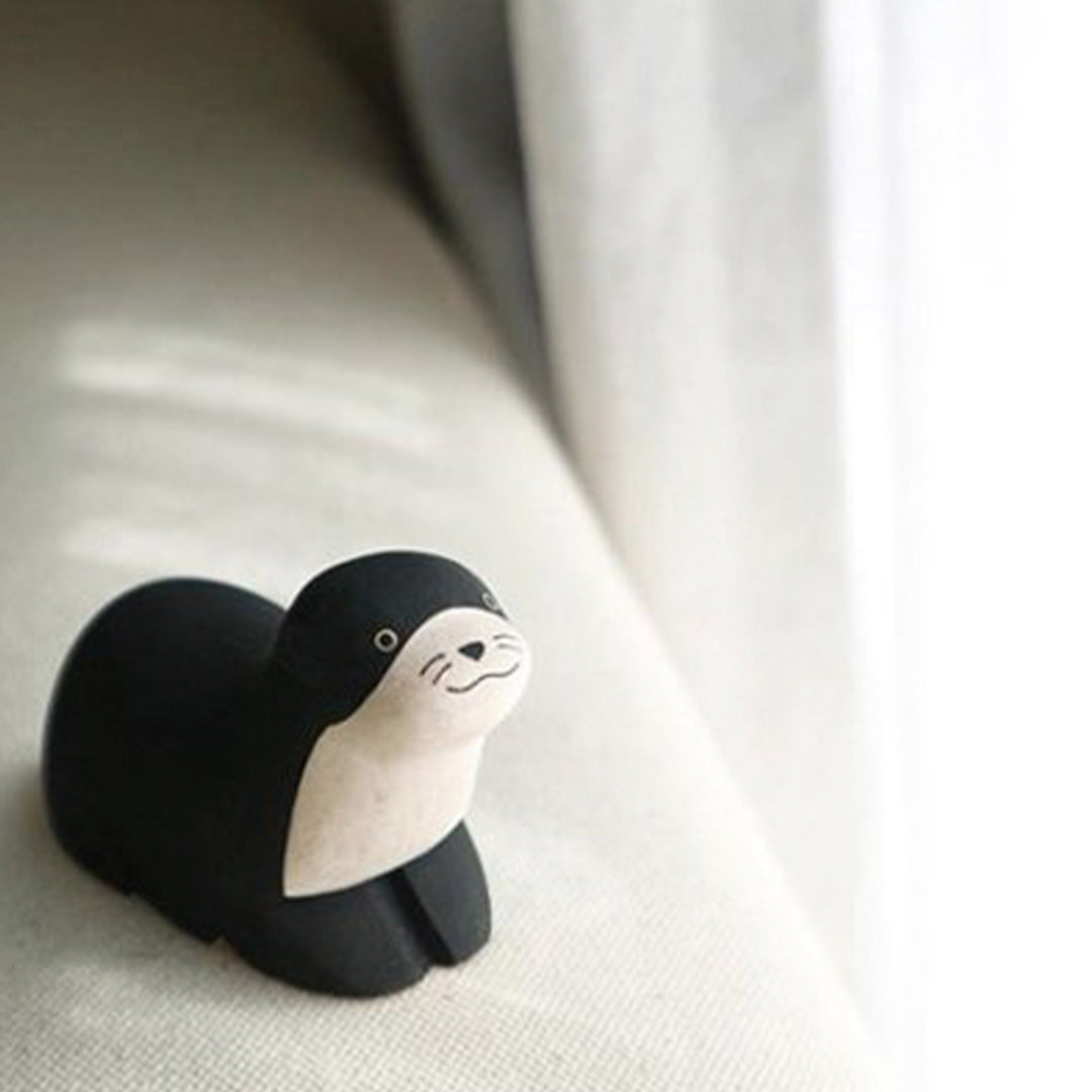 Handmade Wooden Otter from TLab - Cut, carved, finely sanded and hand painted by craftsmen in Bali, each piece is somewhat different and unique.