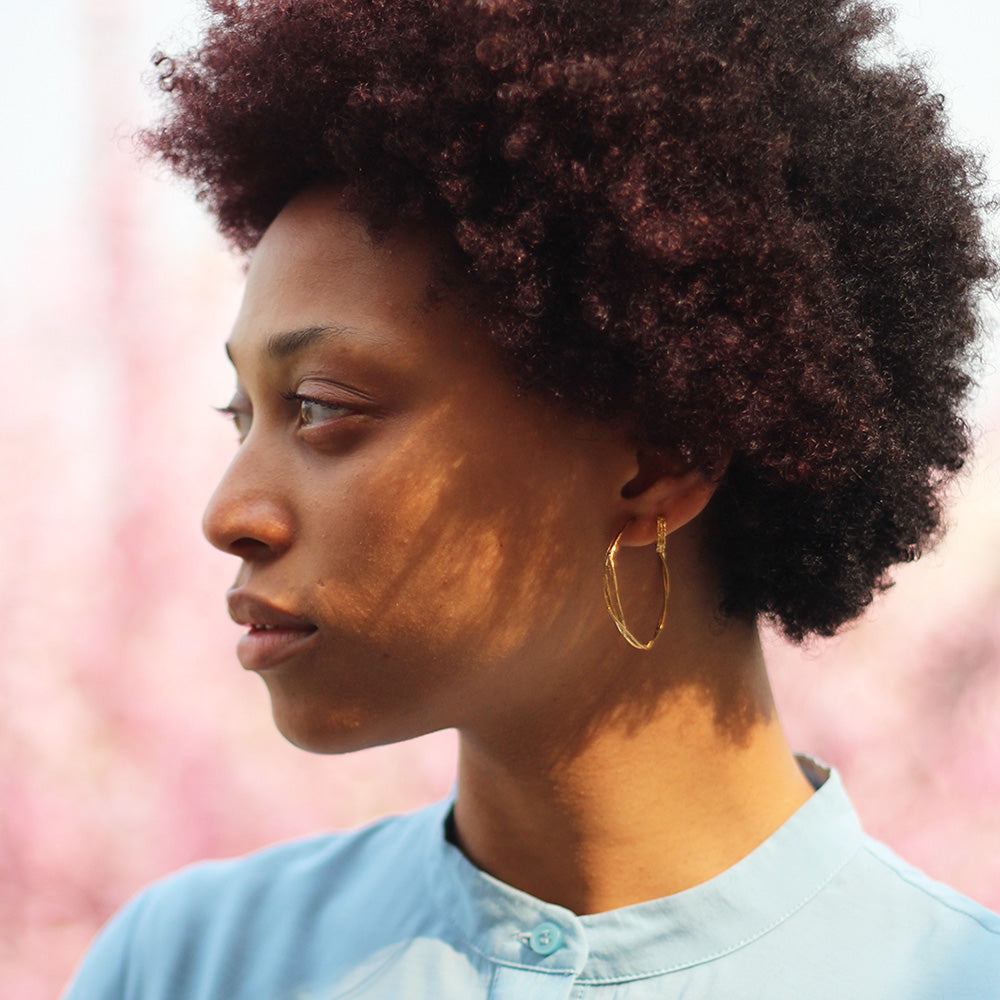 A single vine has curled and twisted around itself to create a pair of elegant, contemporary hoop earrings. Perfect for mixing and matching with other Alex Monroe earrings.