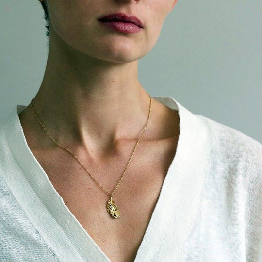 A peacock feather pendant necklace with engraved 'eye' motif from Alex Monroe's Classics jewellery collection.