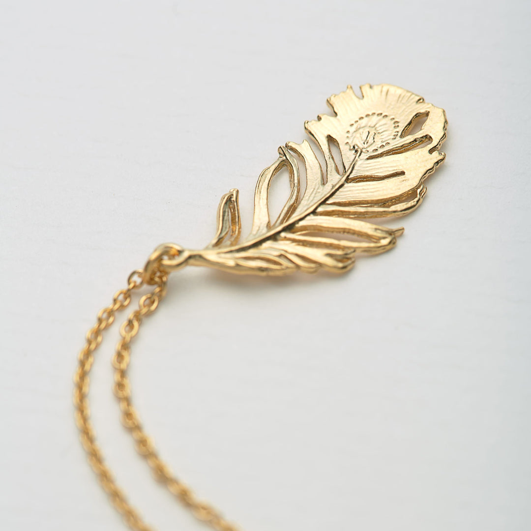 A peacock feather pendant necklace with engraved 'eye' motif from Alex Monroe's Classics jewellery collection.