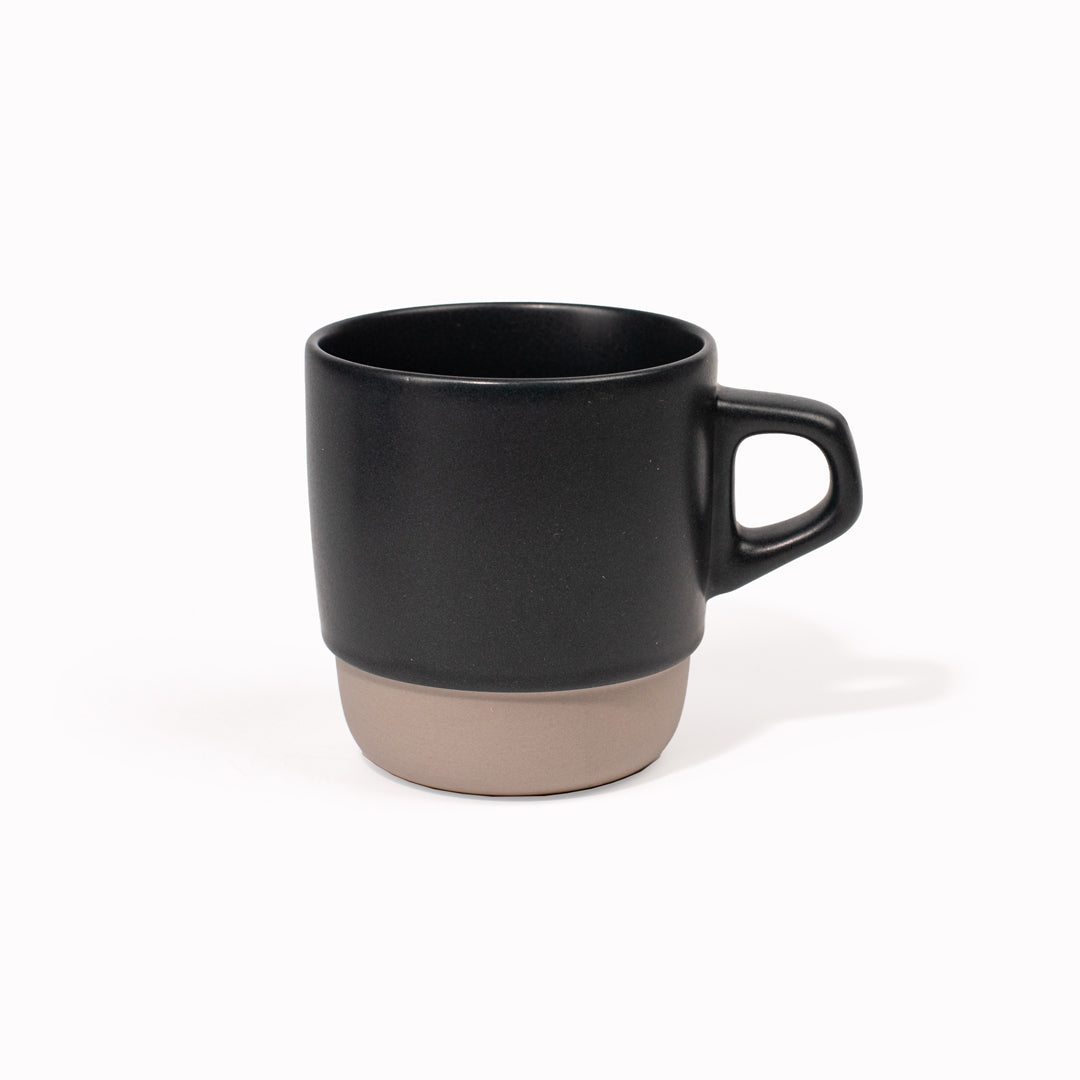 The Blue/Black SCS stacking mug is designed to be used as a coffee cup, as part of the Kinto SCS (Slow Coffee Style) range of coffee brewing and drinking products. Made from Japanese porcelain with a two tone natural and almost black glaze, this mug has a bevelled bottom, which allows it to stack neatly with other mugs in the range for storage. It holds 320ml and is microwave and dishwasher safe.
