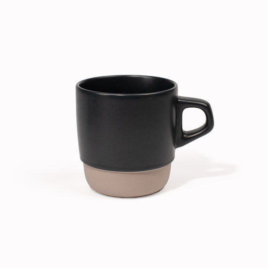 The Blue/Black SCS stacking mug is designed to be used as a coffee cup, as part of the Kinto SCS (Slow Coffee Style) range of coffee brewing and drinking products. Made from Japanese porcelain with a two tone natural and almost black glaze, this mug has a bevelled bottom, which allows it to stack neatly with other mugs in the range for storage. It holds 320ml and is microwave and dishwasher safe.