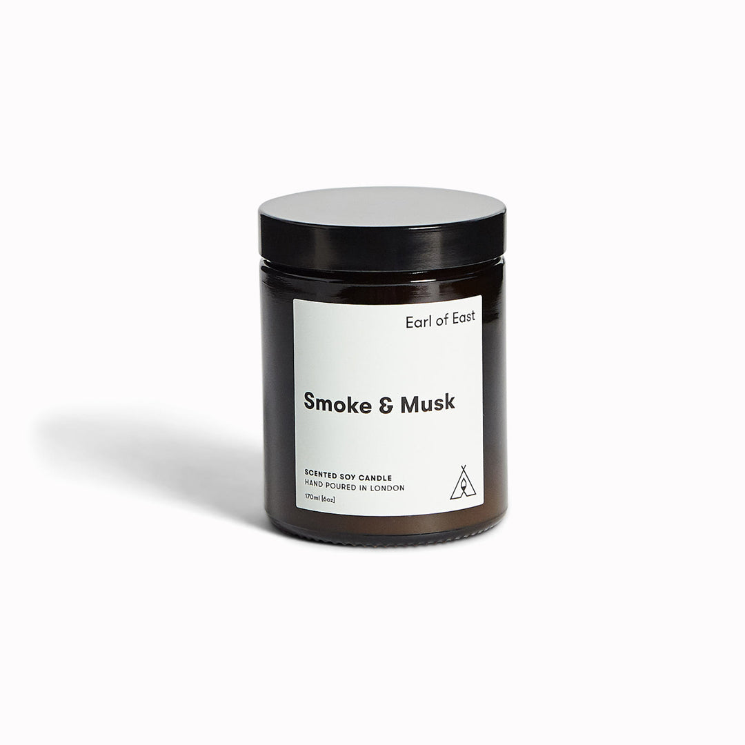 Smoke & Musk candle by Earl Of East, evoking the essence of the great outdoors. A comforting combination of of green balsam fir, wood smoke and patchouli.