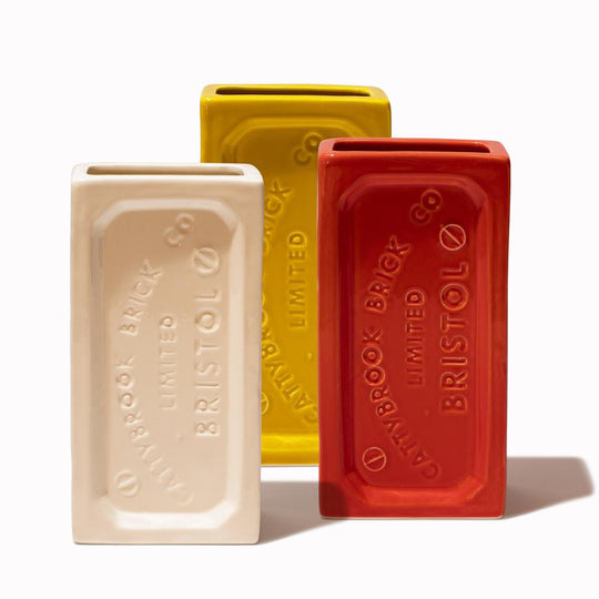 A ceramic vase in the shape of the classic Bristol Brick. Made by StolenForm, a concept brand that specialises in repurposing industrialised objects, transforming them into home accessories and giftware products. The Bristol bricks are watertight, perfect for flowers and plants, or can be used for office stationery or kitchen utensils. This shows the White, Yellow and Orange colours.