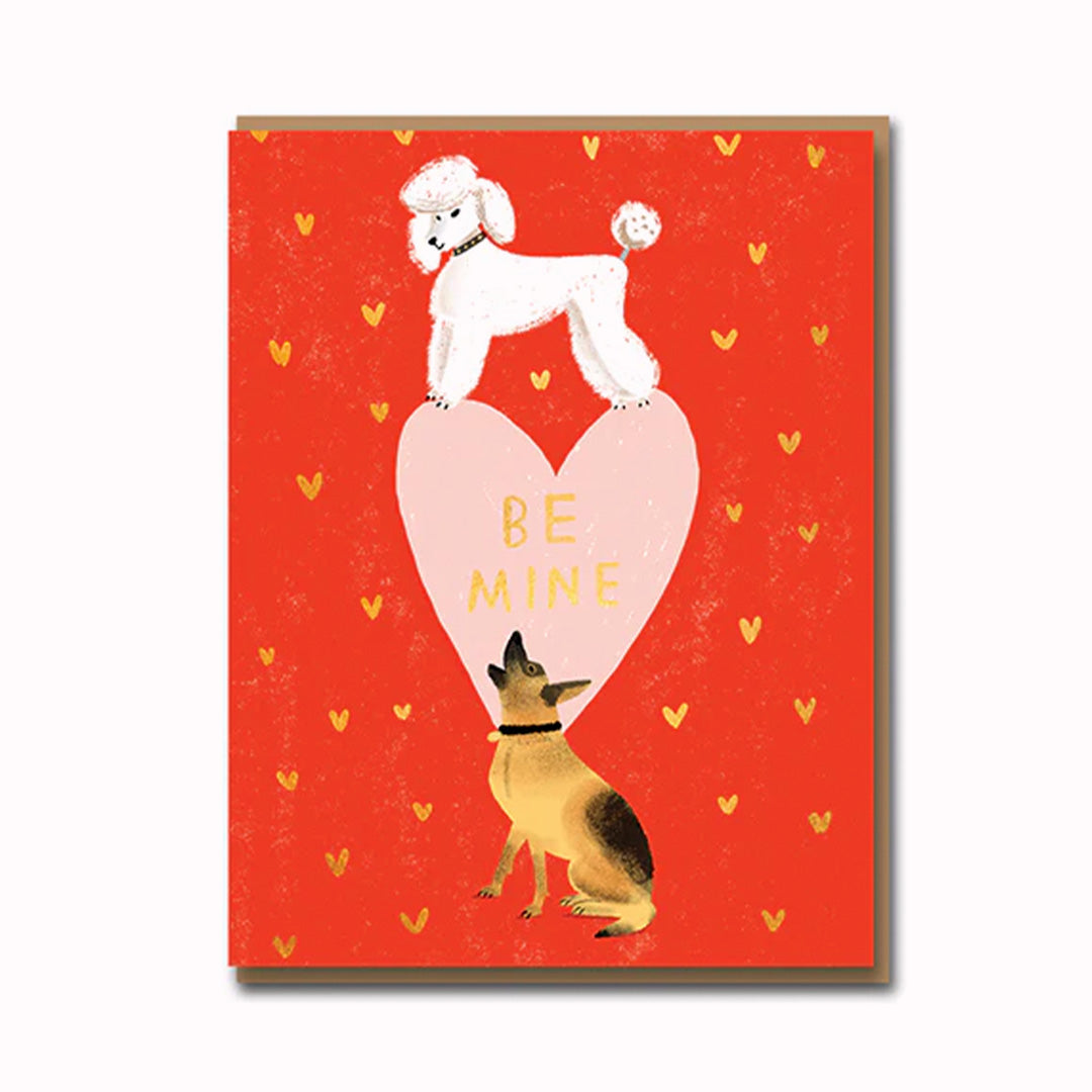 Cute Valentines Day card, featuring two dogs over a Be Mine heart, playfully illustrated by Carolyn Suzuki.