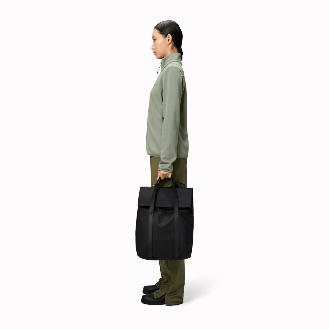 The Rains 2 Way Tote Backpack is characterised by a fold-top opening with the addition signature TPU strap details with top handles.