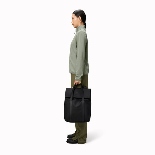 The Rains 2 Way Tote Backpack is characterised by a fold-top opening with the addition signature TPU strap details with top handles.