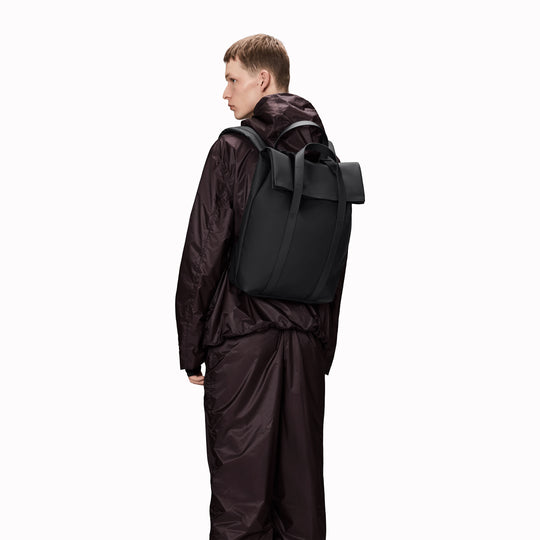 The Rains 2 Way Tote Backpack is characterised by a fold-top opening with the addition signature TPU strap details with top handles.