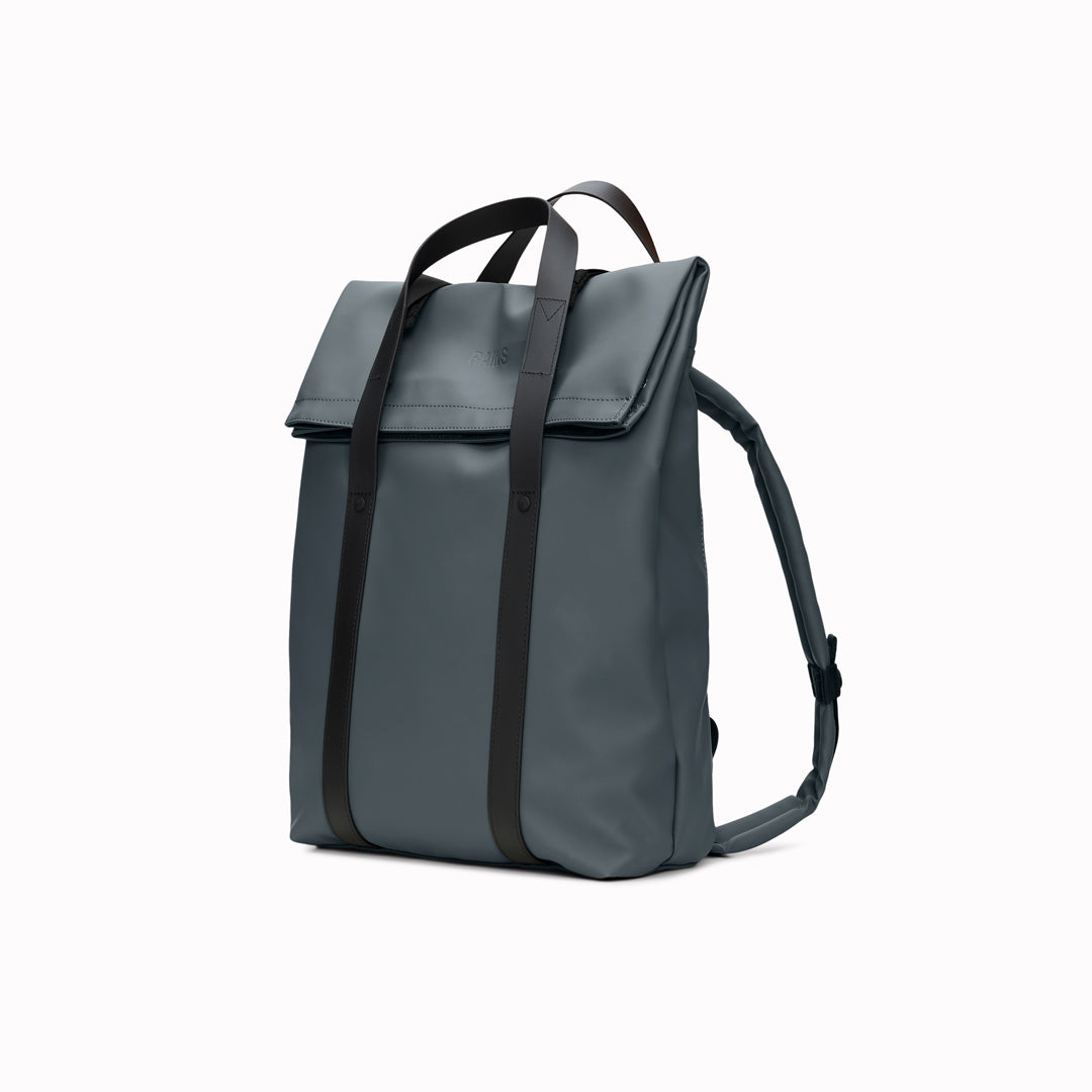 The Rains 2 Way Tote Backpack is characterised by a fold-top opening with the addition signature TPU strap details with top handles.