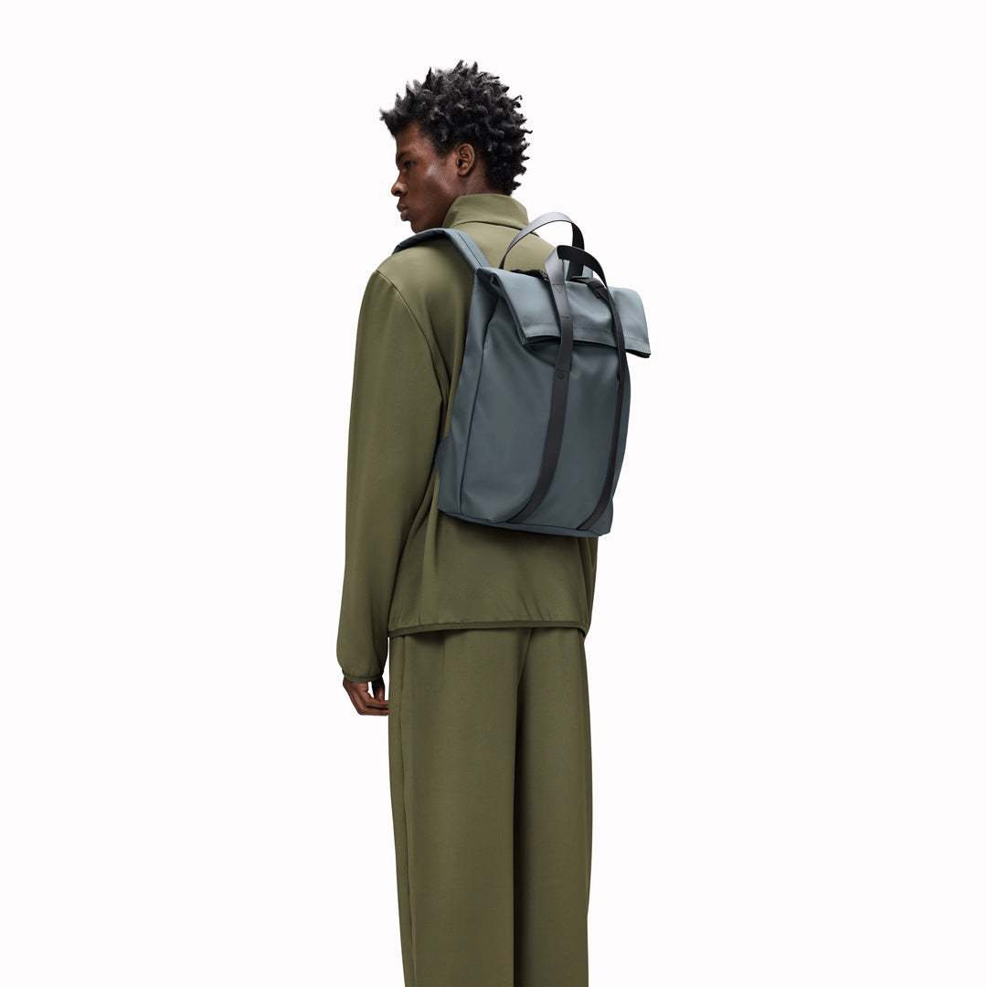 The Rains 2 Way Tote Backpack is characterised by a fold-top opening with the addition signature TPU strap details with top handles.